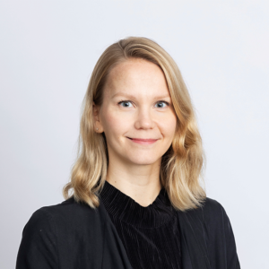 Portrait of Katariina Mustasilta wearing black shirt and black blaiser, blonde hair.