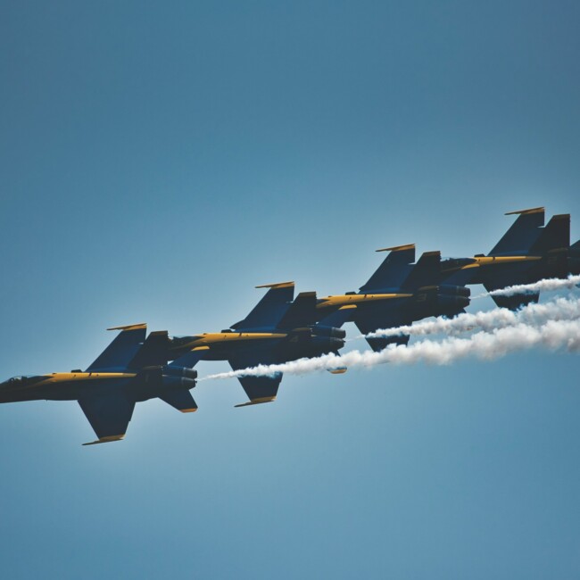 Four fighter jets in the sky.