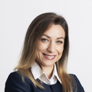 A profile picture of Federica Prandin smiling. She is wearing a white dress shirt with a navy blue jacket on it.