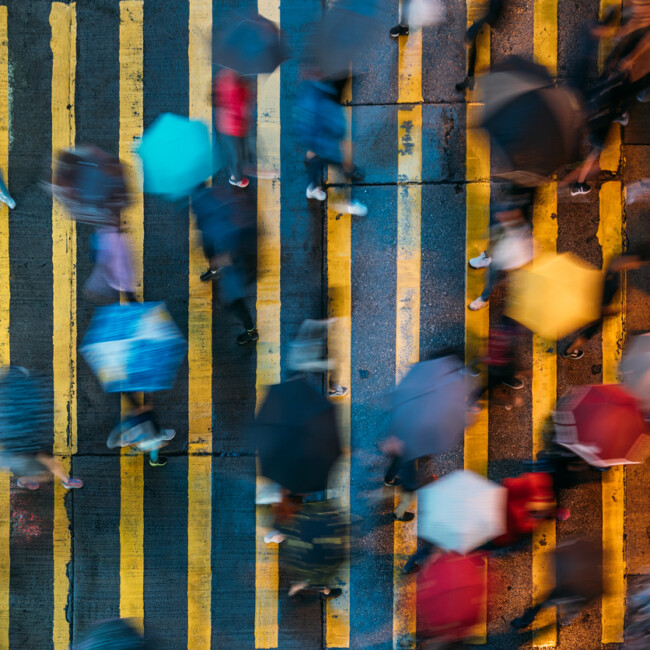 Top view of people crossing a very busy crossroads in Mong Kok district Hong Kong in China