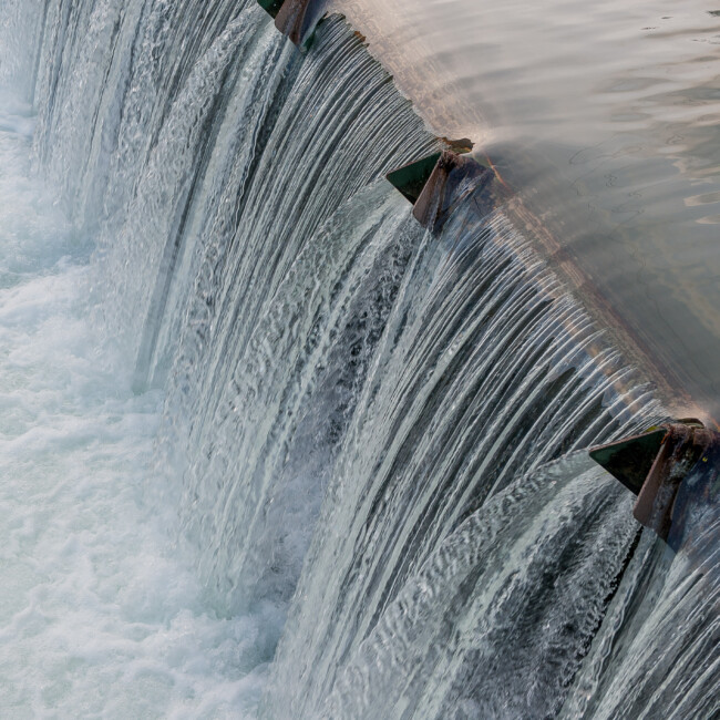 Close-up of water streaming down from a dam