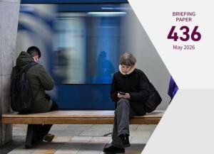 Publication cover showing people scrolling on their phones in a metro station in Moscow.