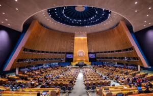 People sitting at a meeting at the UN General Assembly Hall.
