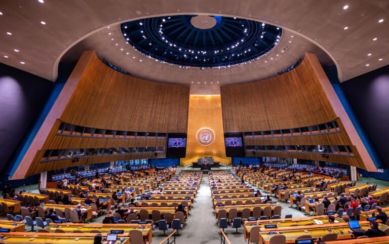 People sitting at a meeting at the UN General Assembly Hall.